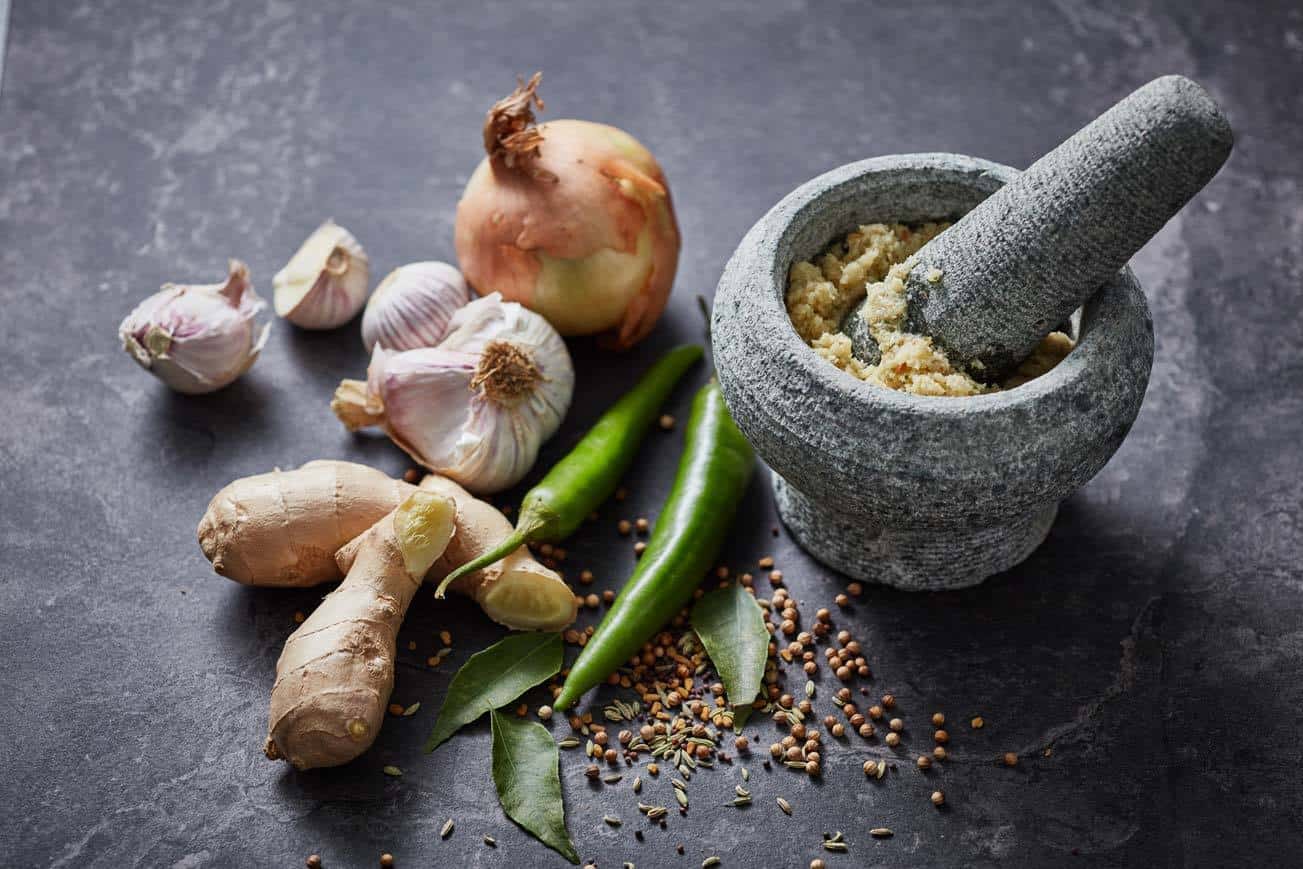 Spices being ground in a pestle and mortar